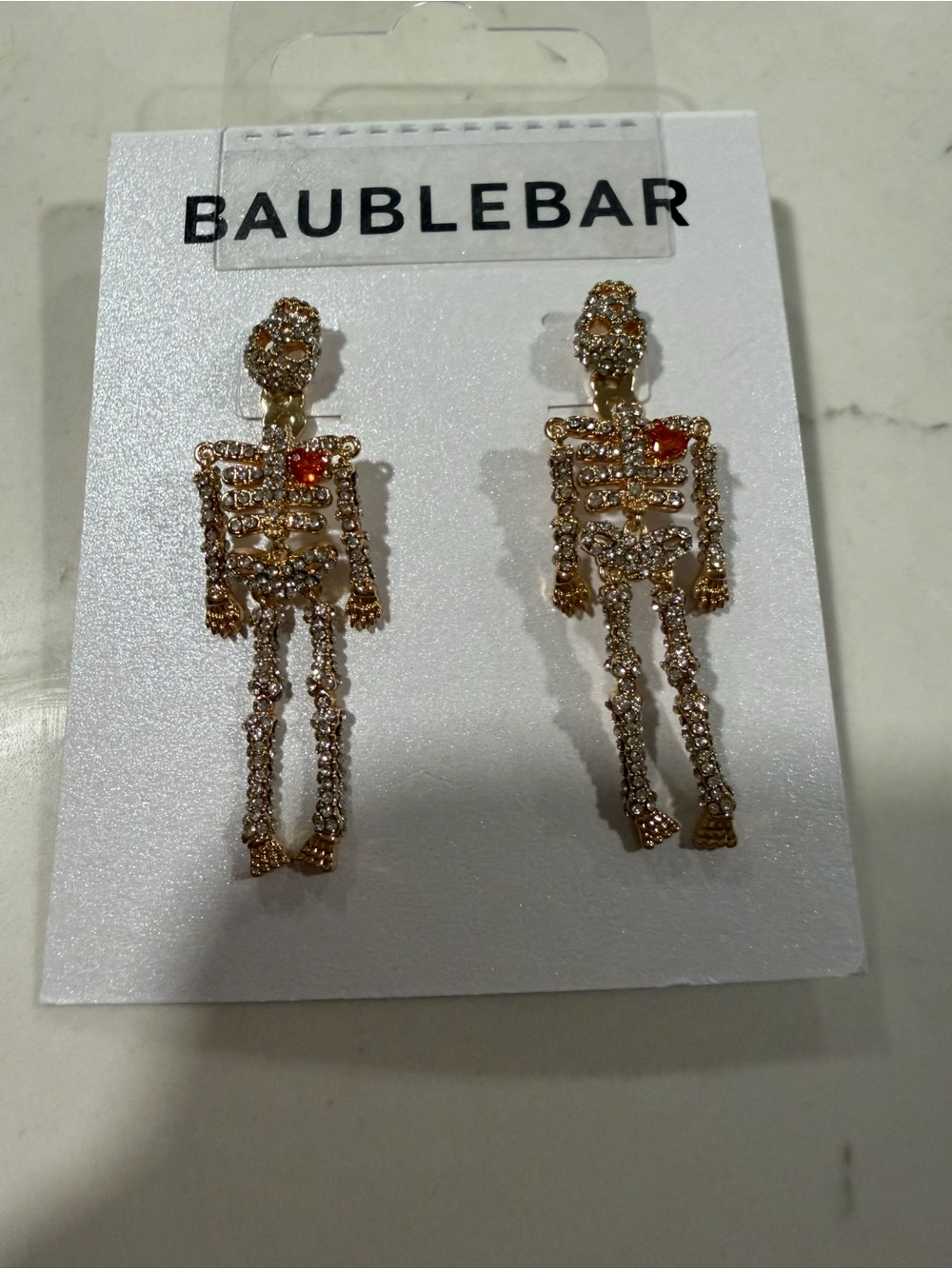 BaubleBar Gold Skeleton Drop Earrings with Red Accent